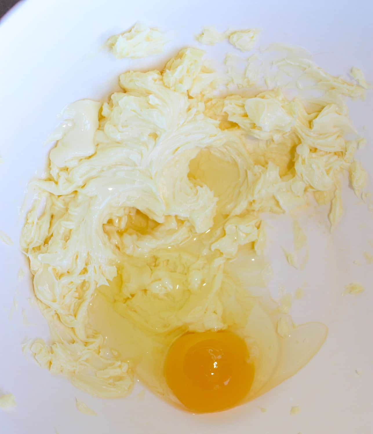 Adding eggs to the creamed shortening.