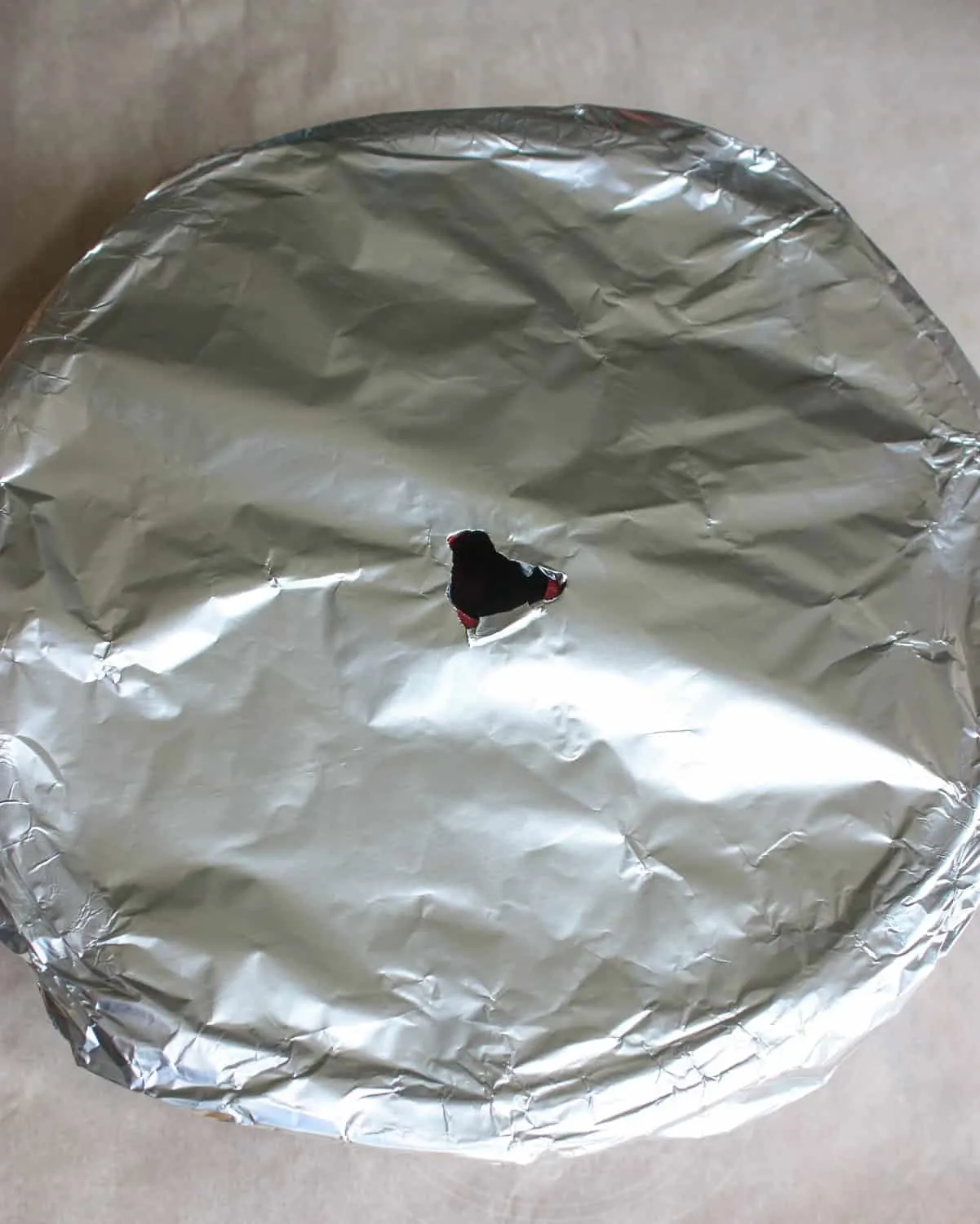 Cover with tin foil and poke hole in centre.
