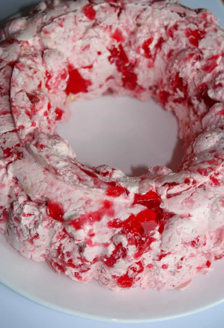 This Strawberry Jello Mold is a tasty variation to add to your holiday get togethers in place of the Orange Jello Mold.  My grown children expect to see one on the table when they return home for the holidays since my Mother introduced them to Jello Molds years ago!