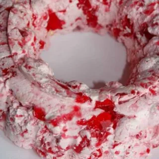 This Strawberry Jello Mold is a tasty variation to add to your holiday get togethers in place of the Orange Jello Mold.  My grown children expect to see one on the table when they return home for the holidays since my Mother introduced them to Jello Molds years ago!