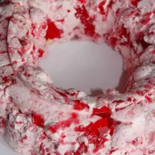 This Strawberry Jello Mold is a tasty variation to add to your holiday get togethers in place of the Orange Jello Mold.  My grown children expect to see one on the table when they return home for the holidays since my Mother introduced them to Jello Molds years ago!