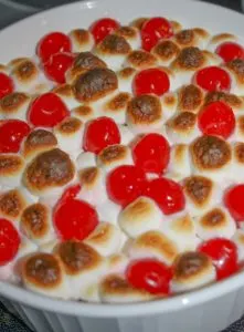 Sweet Potato Casserole is an easy festive side dish to make for the holidays.  The addition of marshmallows and cherries give it a festive flair that will entice even your youngest guests to eat their vegetables!