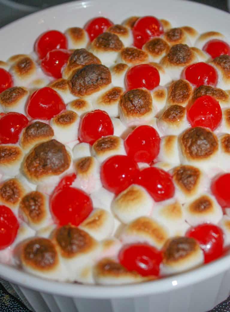 Sweet Potato Casserole is an easy festive side dish to make for the holidays.  The addition of marshmallows and cherries give it a festive flair that will entice even your youngest guests to eat their vegetables!