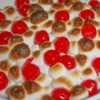 Sweet Potato Casserole is an easy festive side dish to make for the holidays.  The addition of marshmallows and cherries give it a festive flair that will entice even your youngest guests to eat their vegetables!