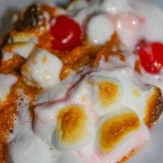 Sweet Potato Casserole is an easy festive side dish to make for the holidays.  The addition of marshmallows and cherries give it a festive flair that will entice even your youngest guests to eat their vegetables!