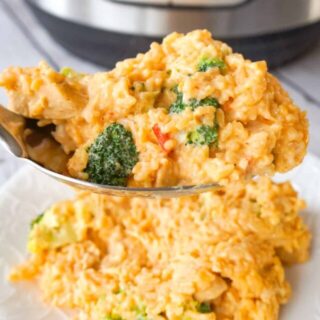Instant Pot Cheesy Broccoli Chicken and Rice is an easy pressure cooker dinner recipe made with long grain rice and loaded with chunks of chicken breast, broccoli florets, salsa con queso, mozzarella, cheddar and Parmesan.