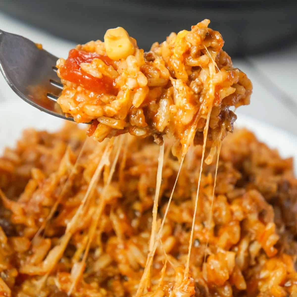 Instant Pot Cheesy Taco Ground Beef and Rice is an easy pressure cooker ground beef dinner recipe made with long grain white rice, corn and black bean salsa and Heinz chili sauce and loaded with shredded mozzarella and cheddar cheese.