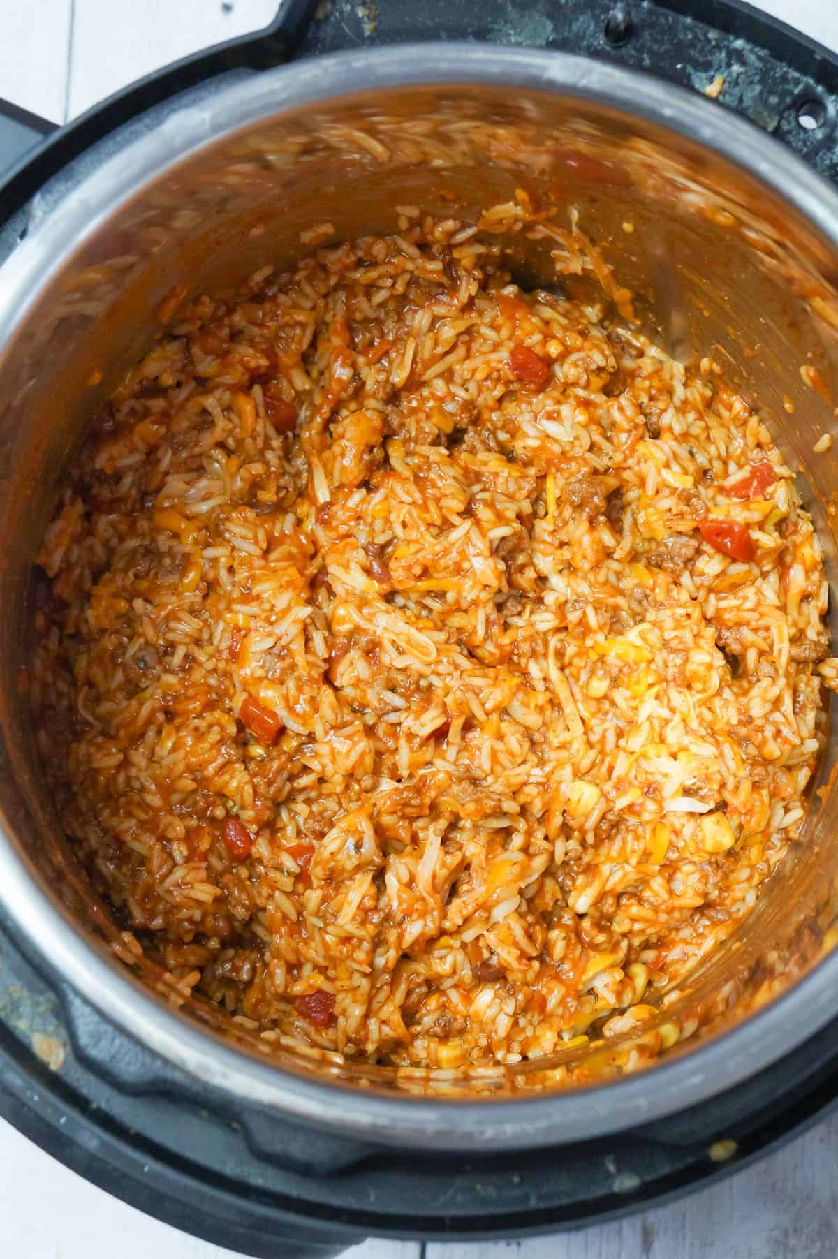 Instant Pot Cheesy Taco Ground Beef and Rice is an easy pressure cooker ground beef dinner recipe made with long grain white rice, corn and black bean salsa and Heinz chili sauce and loaded with shredded mozzarella and cheddar cheese.