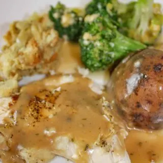 A Whole Chicken Dinner with everything made in one Pot!  A stuffed chicken with sides of potatoes and broccoli in cheese sauce ready before you know it! 