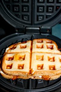 Craving pizza and do not have the time to make gluten free pizza crust from scratch.  Solution....Waffled Grilled Pizza Sandwiches!