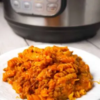 Instant Pot Cheesy Sloppy Joe Pasta is an easy gluten free pasta recipe loaded with ground beef, homemade sloppy joe sauce, mozzarella and cheddar cheese.