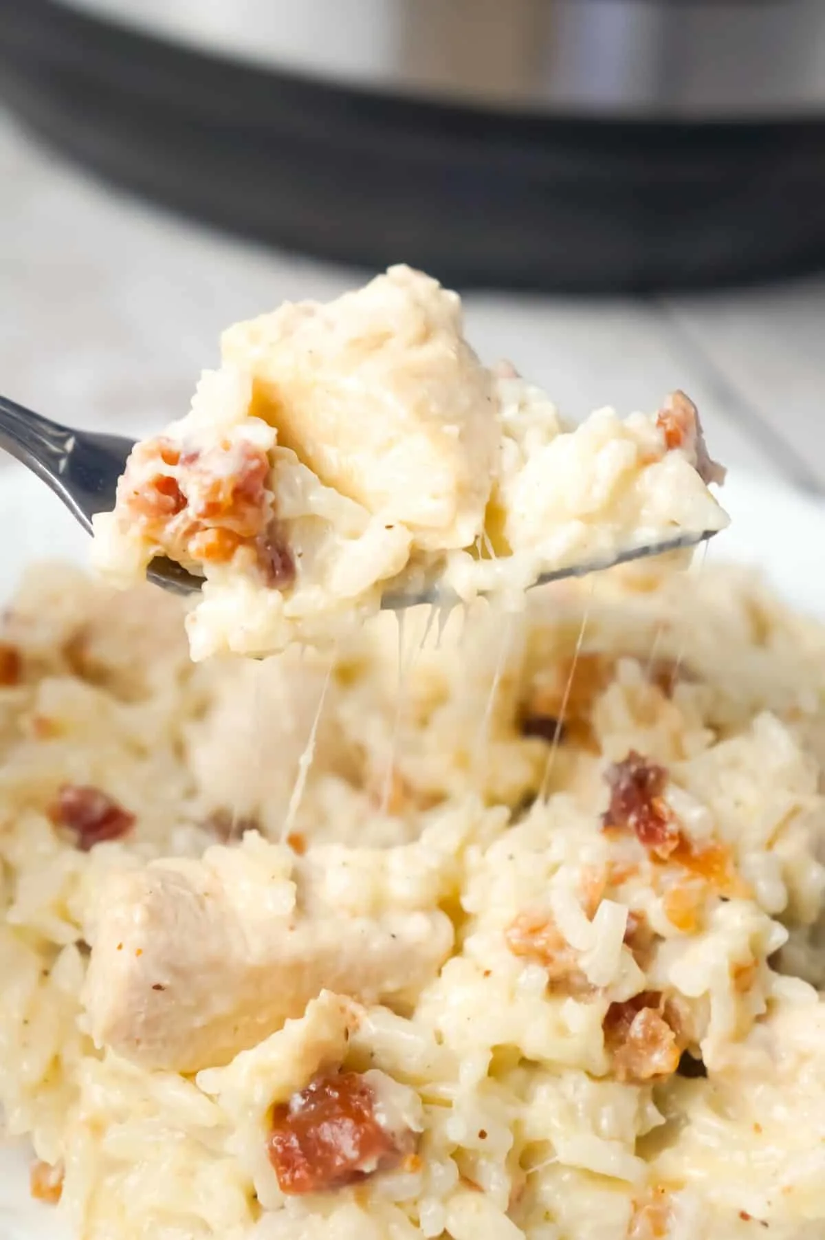 Instant Pot Bacon Parmesan Chicken and Rice is an easy pressure cooker chicken dinner recipe made with boneless, skinless chicken breasts and long grain rice, loaded with crumbled bacon and Parmesan cheese.