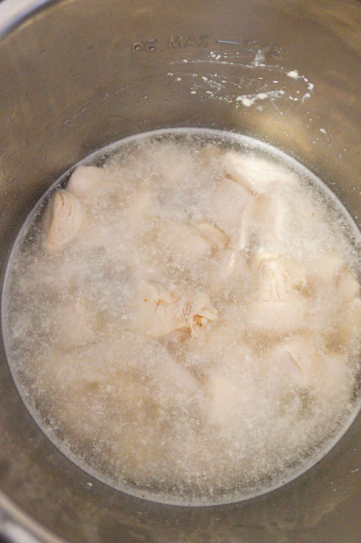 water and chicken breast chunks in an Instant Pot