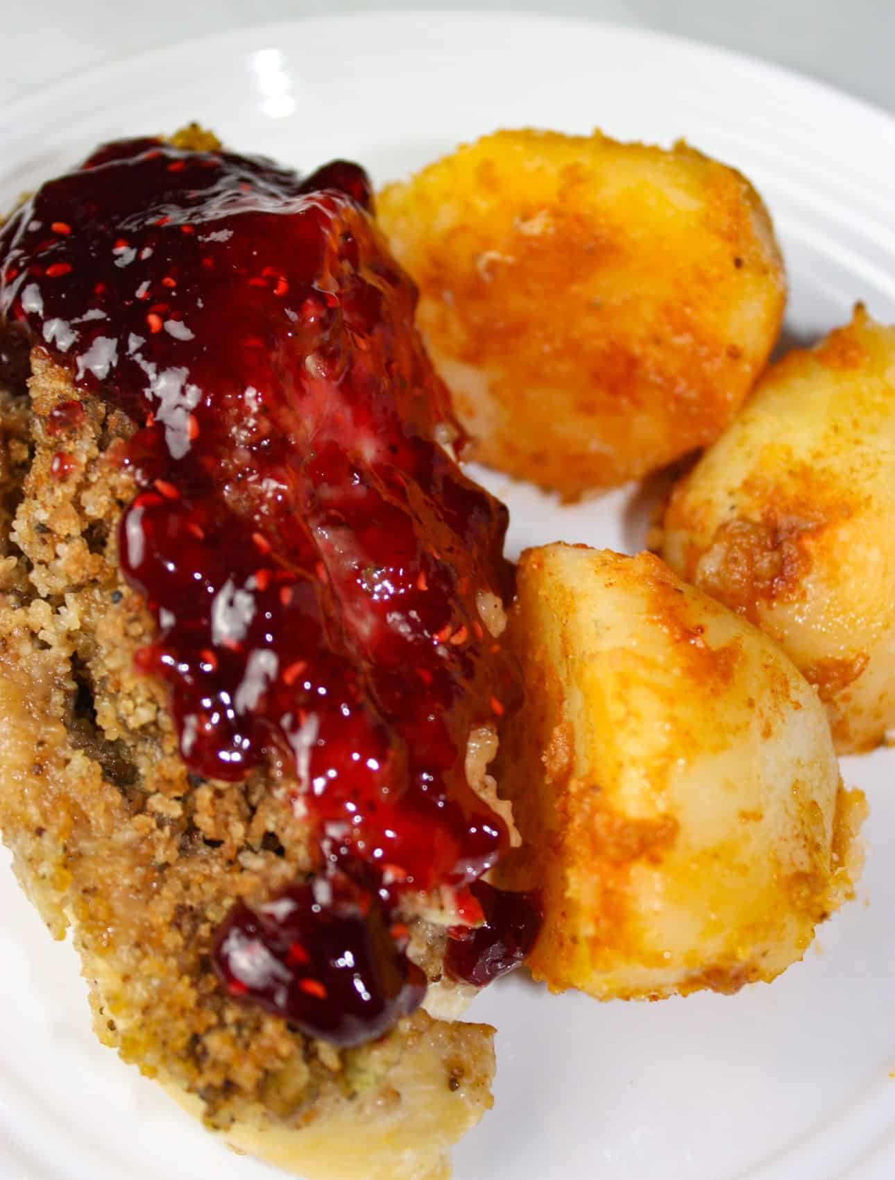Instant Pot Stuffed Chicken Breasts and Seasoned Potatoes is a gourmet style meal that is very appealing when plated.  Each chicken breast is loaded with gluten free stuffing and then smothered in a tangy raspberry sauce.  