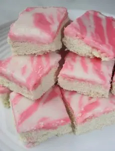 If your life is too busy to make cut out cookies for Valentine's Day this is a great alternative. Iced Sugar Cookie Squares are a sweet and pretty dessert that would be a hit at any Valentine gathering.