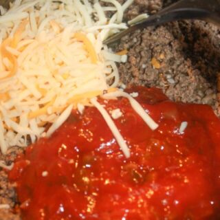 Adding a portion of the shredded cheese and salsa.