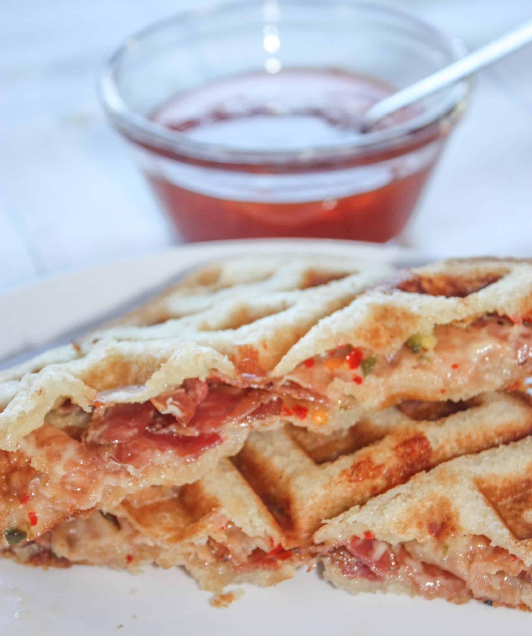 Peppery mozzarella cheese, topped with bacon slices, layered between slices of gluten free bread pressed in the waffle iron to create an appetizing delight.  Spicy Waffled Grilled Cheese with Bacon wakes up the taste buds with a burst of heat.  