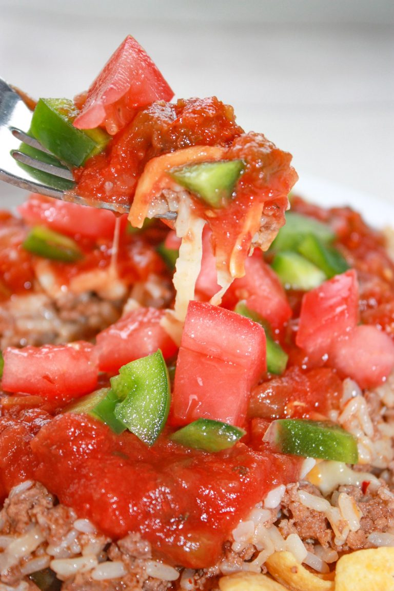 Instant Pot Ground Beef Taco Pile Ons are a taste and texture explosion all in one bite!  This gluten free meal is loaded with ground beef, rice, cheese,salsa and fresh vegetables.  These are all layered on a crust of crunchy corn chips.