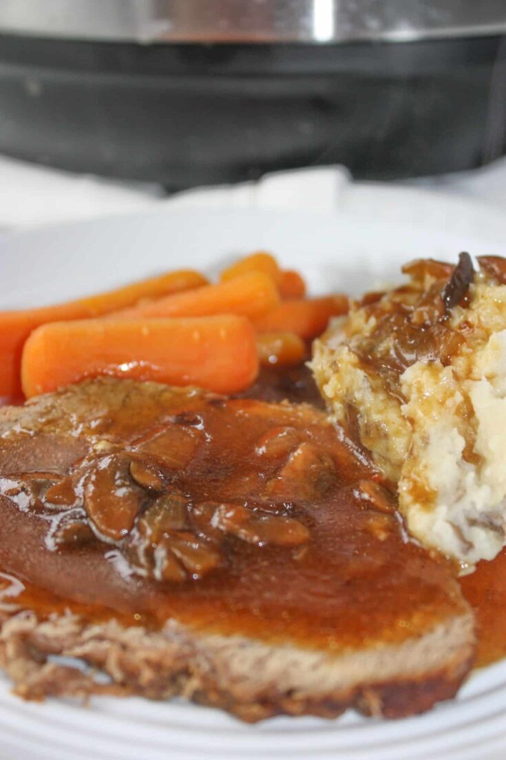 Sunday dinner is served in a fraction of the time!  Instant Pot Sirloin Tip Roast is so tender and served up with sides of baby carrots and potatoes.  Finish it off by covering it in a gluten free mushroom gravy.