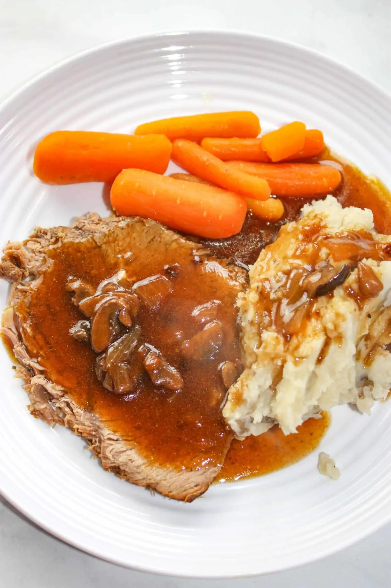 Sunday dinner is served in a fraction of the time!  Instant Pot Sirloin Tip Roast is so tender and served up with sides of baby carrots and potatoes.  Finish it off by covering it in a gluten free mushroom gravy.