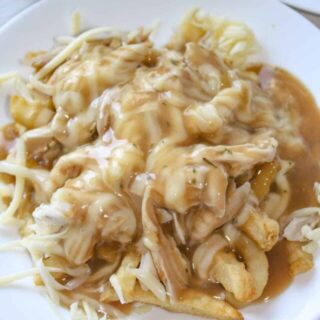 Chicken Cheese Fries is a simple, yet tasty meal, that can be prepared quickly with few ingredients.  This variation of traditional poutine is a great way to use up some leftover chicken or just grab a precooked rotisserie chicken to shred!