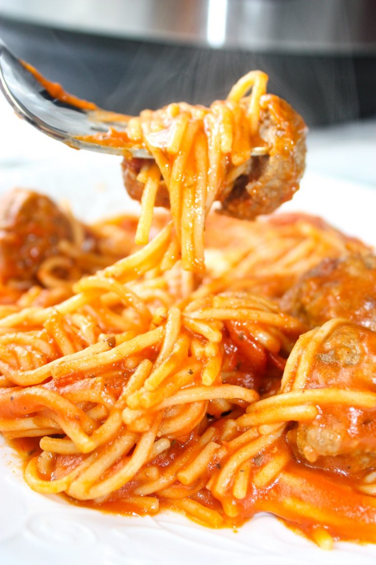 Instant Pot Spaghetti and Meatballs is an easy and delicious pressure cooker pasta recipe.  This family dinner recipe uses gluten free pasta and is loaded with gluten free meatballs and Tomato Basil pasta sauce.