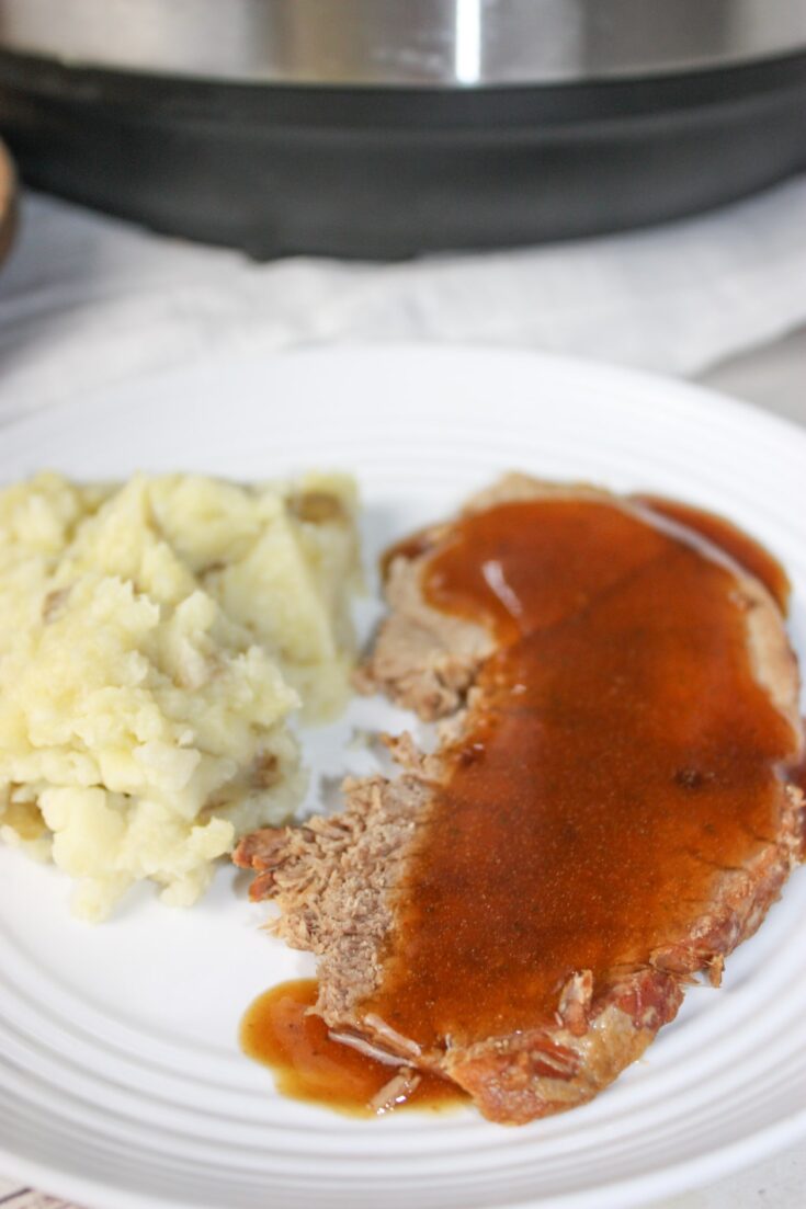 Instant Pot Beef Round Roast with Gravy takes a tougher cut of beef and turns it into a moist and tender main course.  This pressure cooker recipe makes it easy to serve up Sunday Dinner any day of the week!