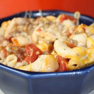 Baked Macaroni and Cheese is a quick and easy recipe your whole family will enjoy.  This gluten free meal is loaded with elbow pasta, ground beef, tomato and cheese to create a hearty meal for any day of the week.