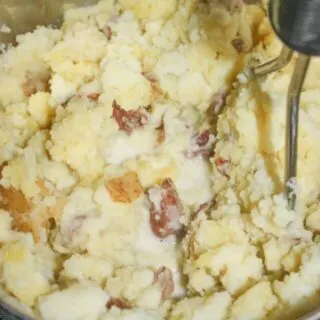 Mashing the potatoes.