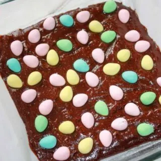 Spreading the mini eggs evenly over top of the brownie batter.