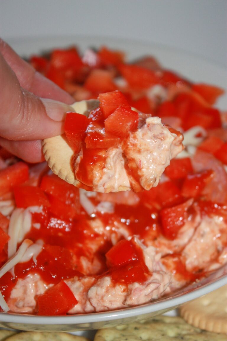 Pizza Dip is a quick and easy appetizer recipe that will be enjoyed by young and old alike.  All your pizza lovers will devour this cold dip that is loaded with cheese, pepperoni, bacon and peppers.