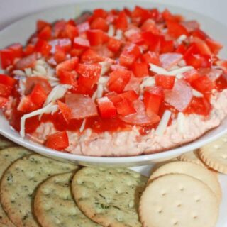 Pizza Dip is a quick and easy appetizer recipe that will be enjoyed by young and old alike.  All your pizza lovers will devour this cold dip that is loaded with cheese, pepperoni, bacon and peppers.