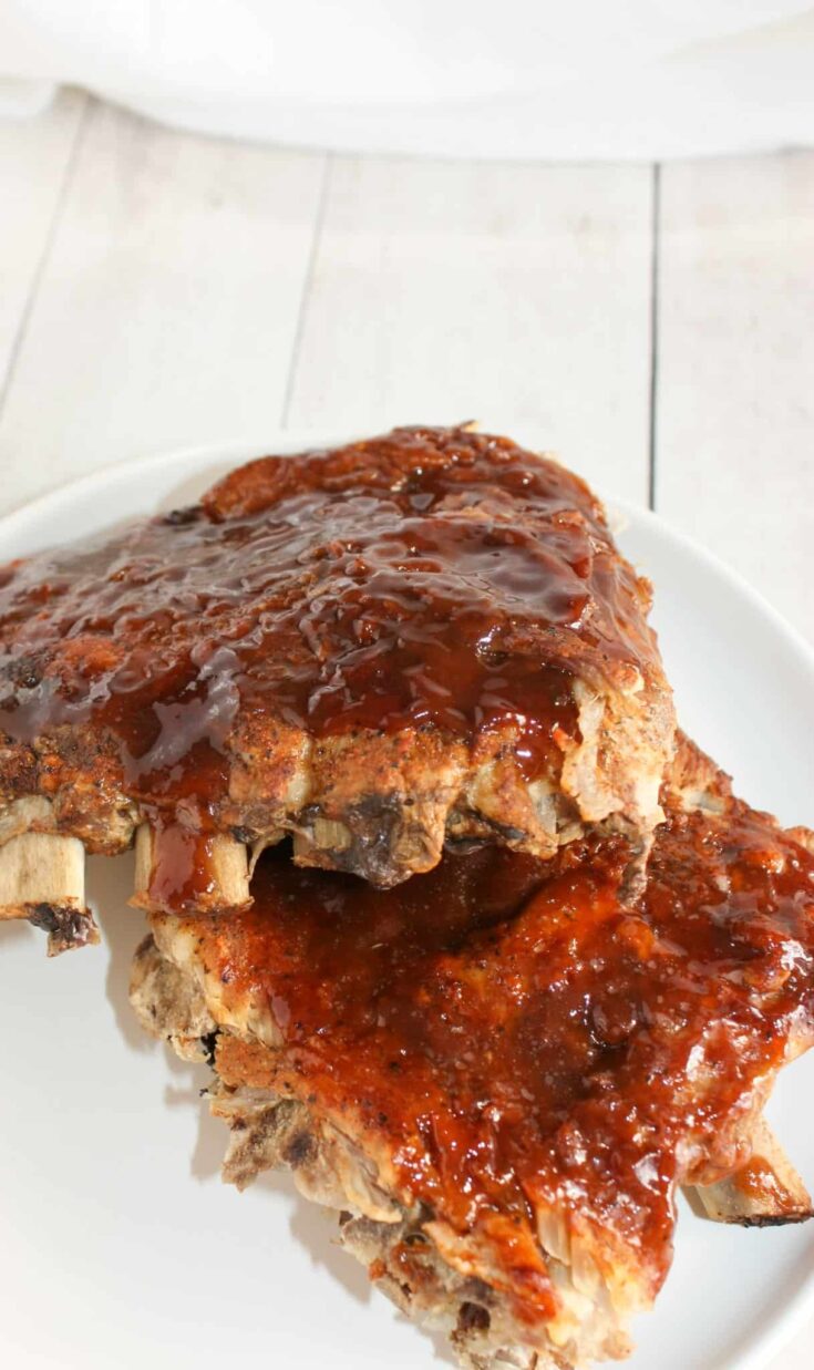 Instant Pot Ribs is a decadent fall off the bone dinner recipe. &nbsp;Rubbed with spices and smothered in sauce, these gluten free pork ribs are sure to please the palate.