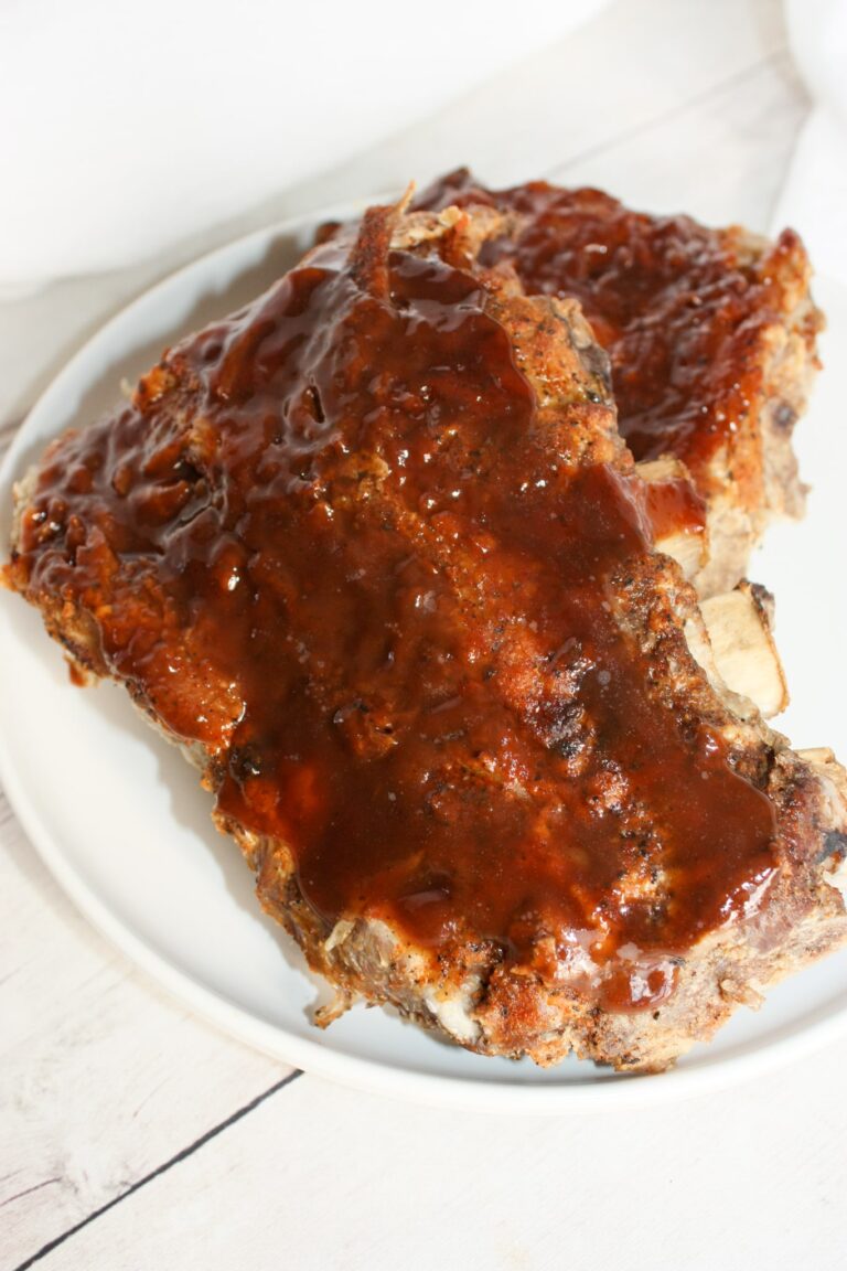 Instant Pot Ribs is a decadent fall off the bone dinner recipe.  Rubbed with spices and smothered in sauce, these gluten free pork ribs are sure to please the palate.