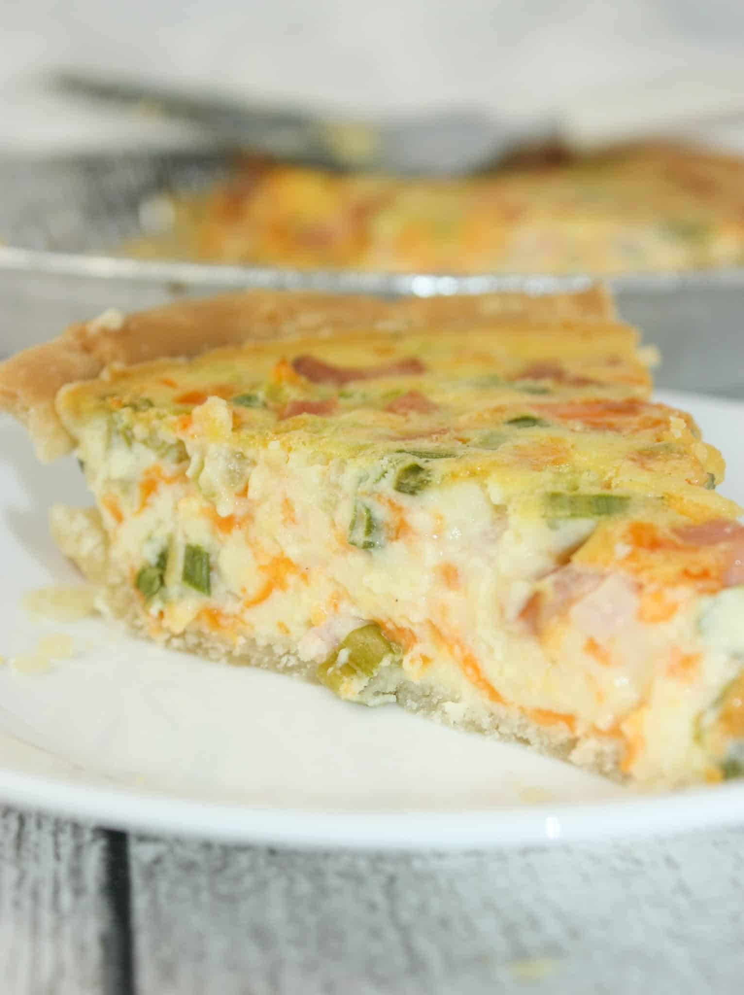 If you are looking for an easy quiche recipe, for your next brunch or light dinner, this is the perfect recipe for you!  This tasty Ham and Cheese Quiche is easy to make gluten free with your choice of pie shell.