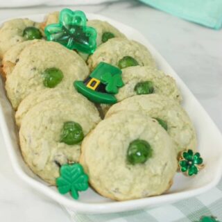 Mint Chocolate Chip Cookies are a tasty variation to traditional chocolate chip cookies.  Add some green colouring, mint chips and green cherries to give these cookies a festive flair for St. Patrick's Day or for your Holiday dessert trays!
