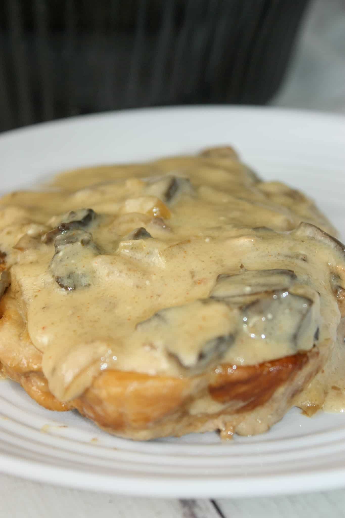 Crock Pot Pork Chops with Mushrooms is an easy slow cooker recipe for any time of the year.  Bone in pork chops smothered in a creamy mushroom gravy makes a wonderful comfort food main course.