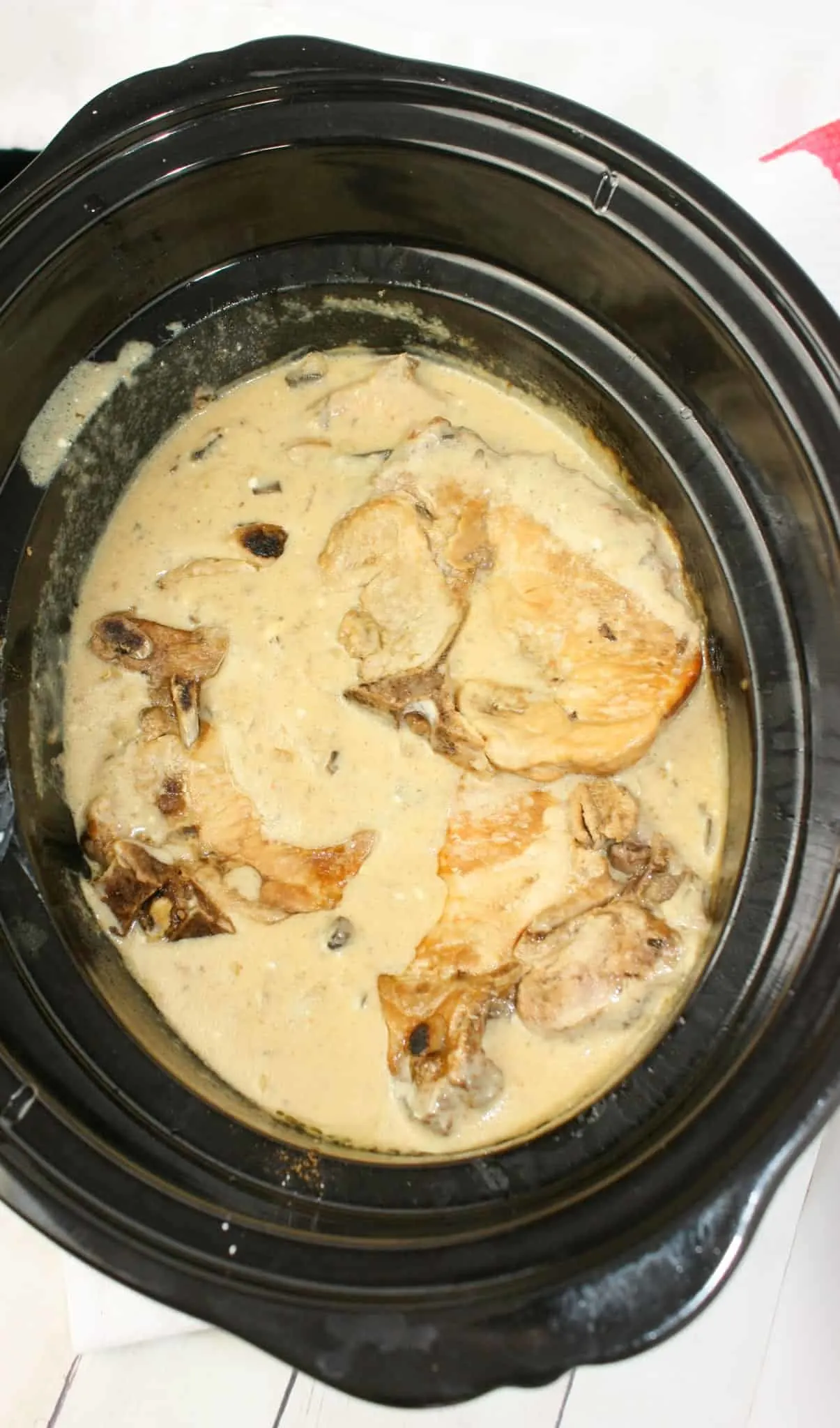 Crock Pot Pork Chops with Mushrooms is an easy slow cooker recipe for any time of the year.  Bone in pork chops smothered in a creamy mushroom gravy makes a wonderful comfort food main course.