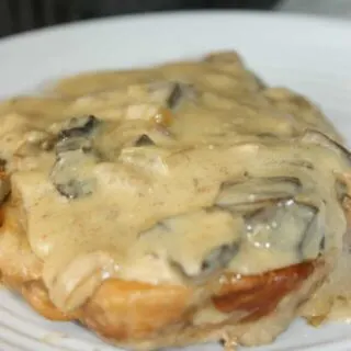 Crock Pot Pork Chops with Mushrooms is an easy slow cooker recipe for any time of the year.  Bone in pork chops smothered in a creamy mushroom gravy makes a wonderful comfort food main course.