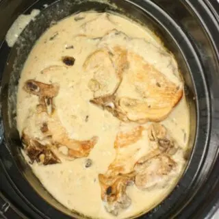 Crock Pot Pork Chops with Mushrooms is an easy slow cooker recipe for any time of the year.  Bone in pork chops smothered in a creamy mushroom gravy makes a wonderful comfort food main course.