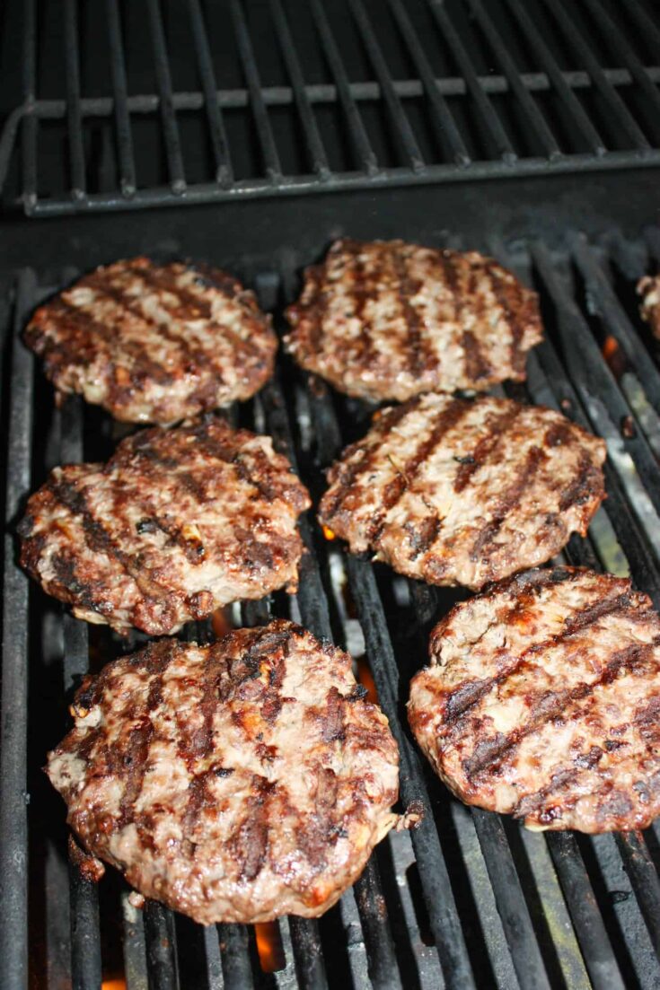 Flip the burgers to continue cooking on the other side.