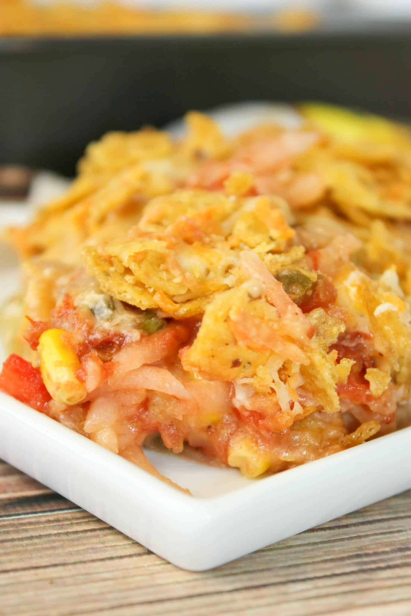 Mexican Potato Casserole is an easy side dish that is sure to be a hit with young and old alike!   The crispy topping is the perfect complement to the cheesy, potato base.