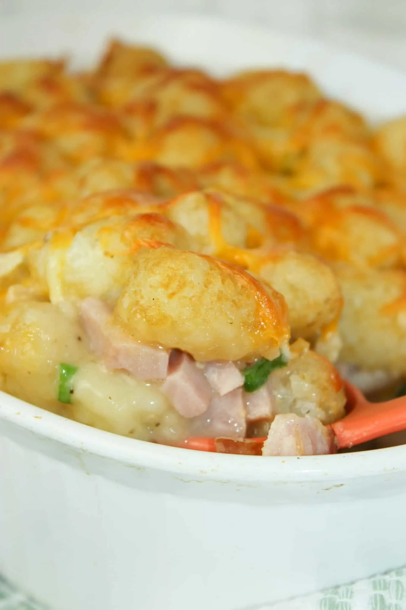 Tater Tot Casserole with Ham is an easy dinner recipe that is loaded with crunchy tater tots and cooked ham.  The gluten free condensed cream of chicken soup not only adds moisture but flavour as well.