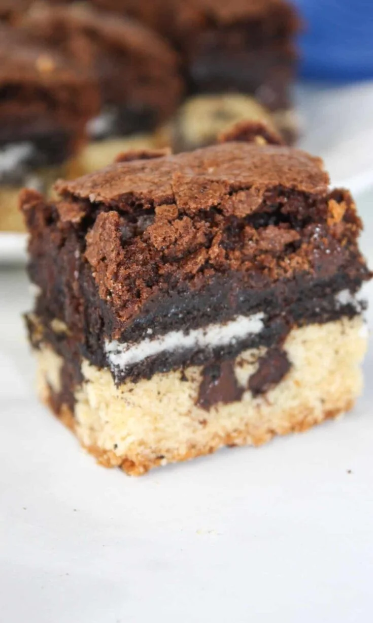 Gluten Free Slutty Brownies are delicious triple layer brownies with a chocolate chip cookie base, Oreo middle and chocolate brownie batter on top.