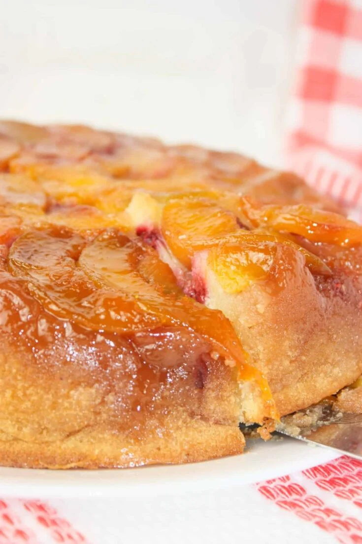 Peach Raspberry Upside Down Cake is a visually stunning dessert featuring a juicy, caramelized fruit topping over a soft, tender cake.