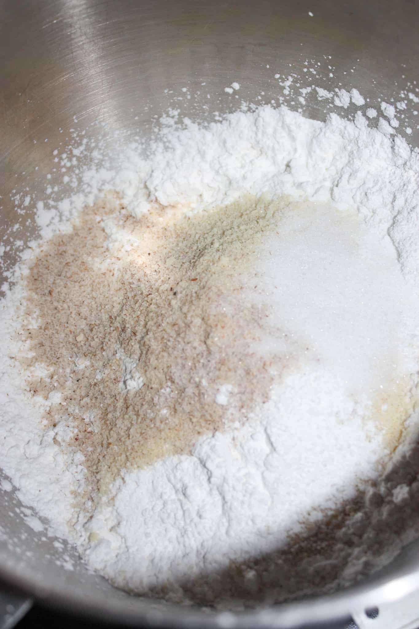 Dump the caputo flour, almond flour, psyllium husk powder, baking powder salt and sugar into the bowl of a stand mixer.