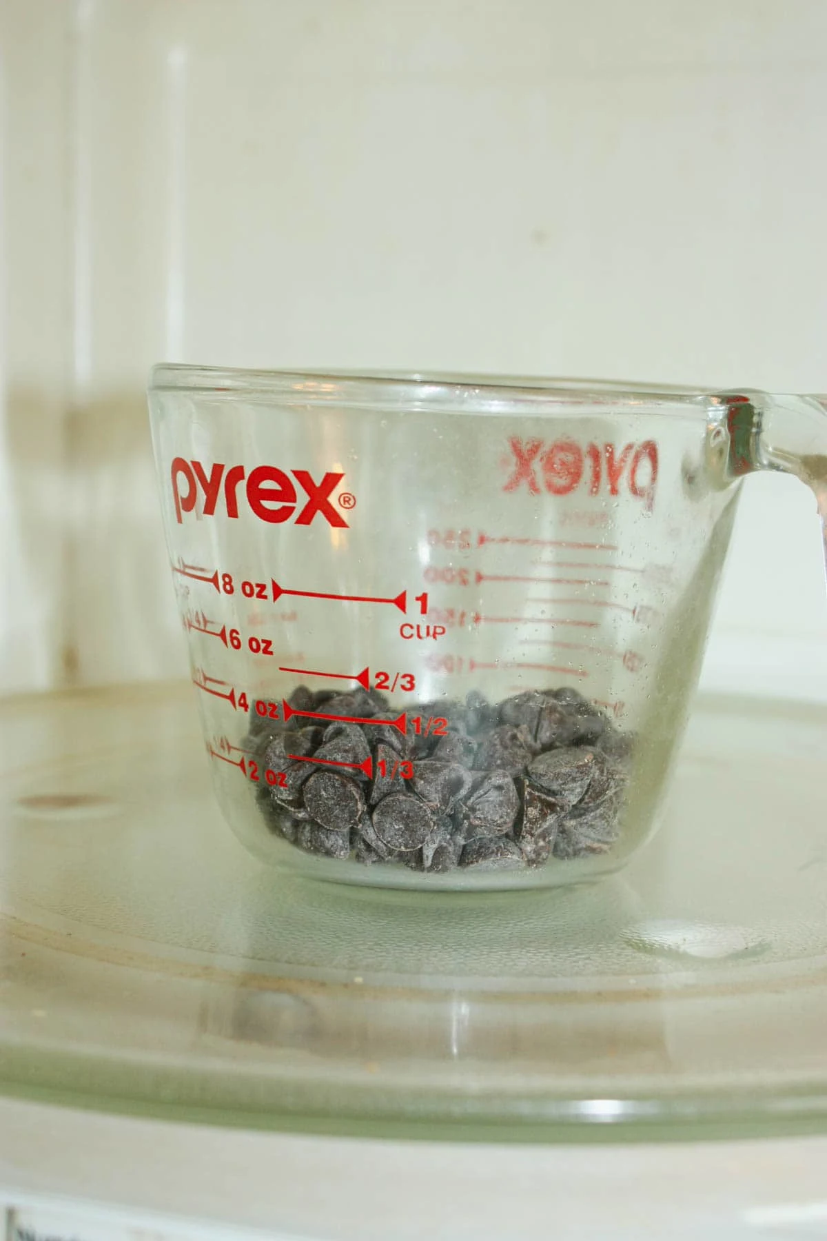 Melt some semi sweet chocolate chips and some coconut oil in the microwave.