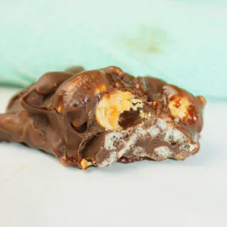 Crispy Peanut Clusters are little mounds of sweet, perfection that crunch with every bite.  The glossy chocolate shell melts on your tongue while the crisp rice and roasted peanuts create a satisfying snap.