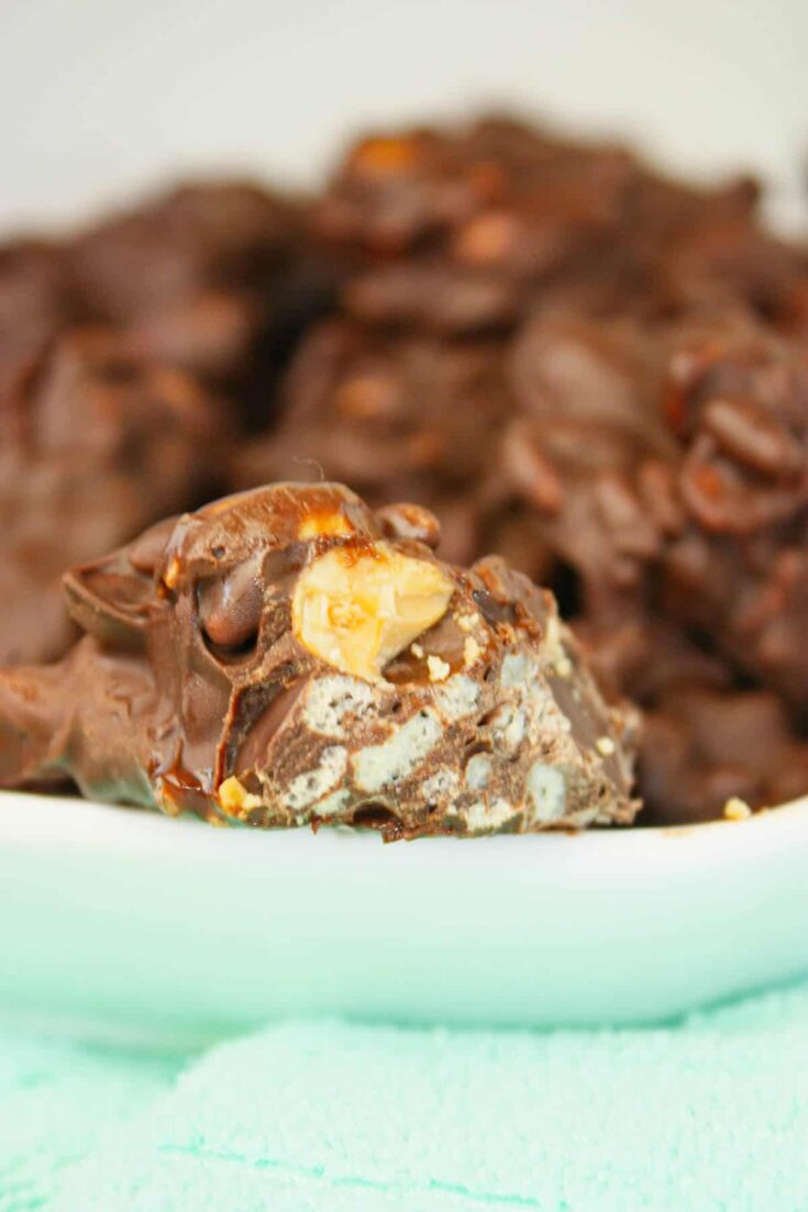 Crispy Peanut Clusters are little mounds of sweet, perfection that crunch with every bite.  The glossy chocolate shell melts on your tongue while the crisp rice and roasted peanuts create a satisfying snap.