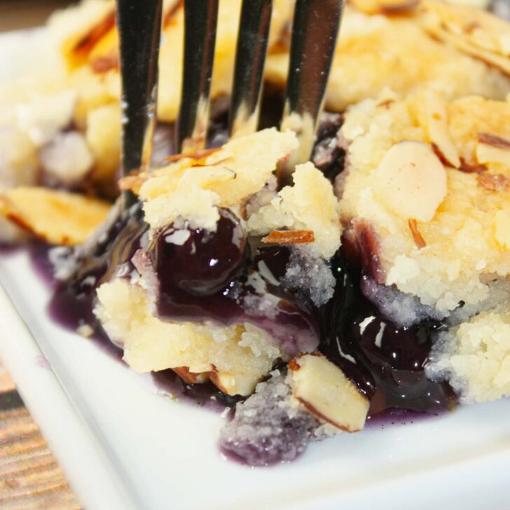 Blueberry Peach Dump Cake is bursting with juicy fruit flavour in every bite. Sweet peaches and plump blueberries mingle together under a golden, buttery cake topping. 